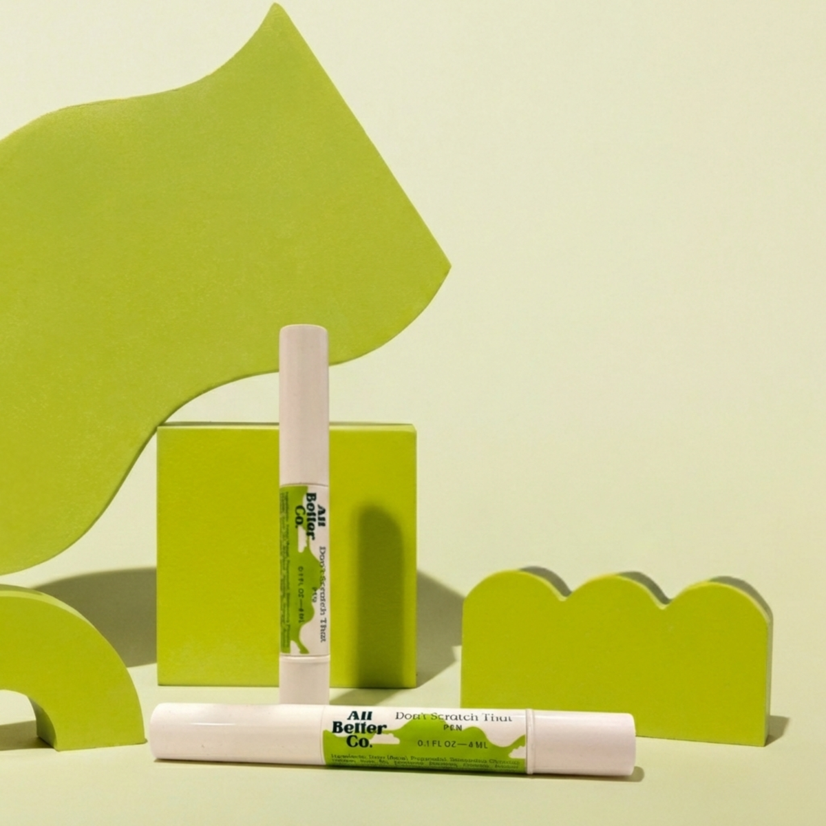 Two don't scratch that pens with green and white design on a light green background