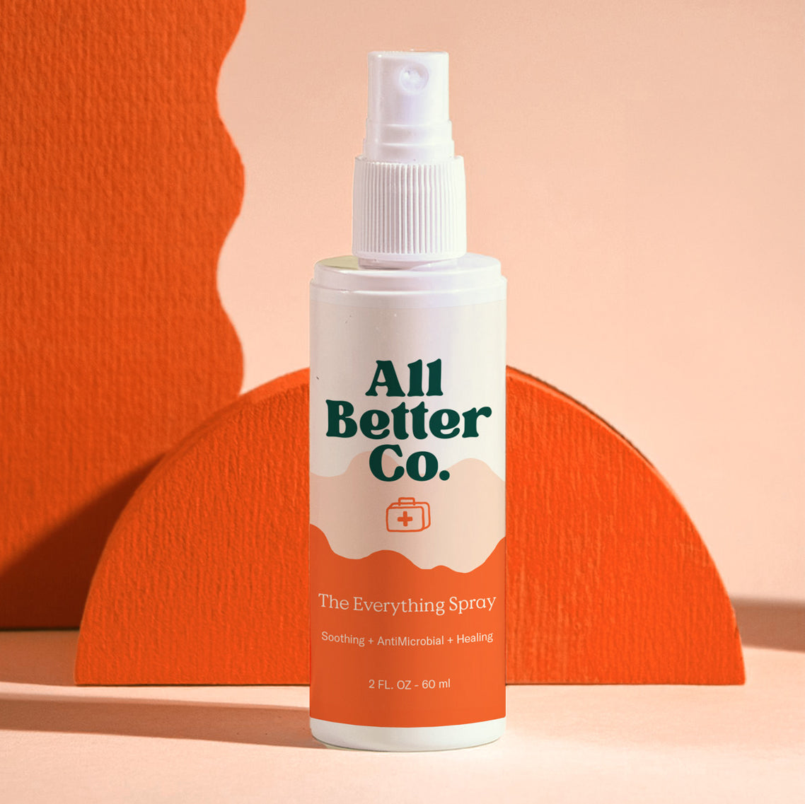A spray bottle labeled 'All Better Co. - The Everything Spray' against an orange backdrop.